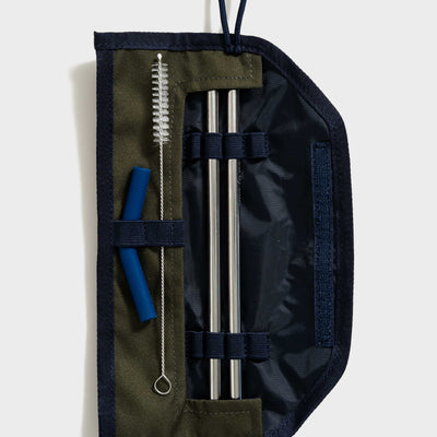 Olive The Straw Kit (Flat-lay): Open olive and navy roll case with two steel straws, brush, and blue silicone tips