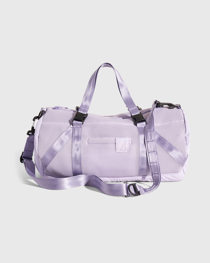 Lavender (Re)active™ 16L Mini Duffle (Angle): Light purple mesh duffle with satin straps, black buckles, and logo patch