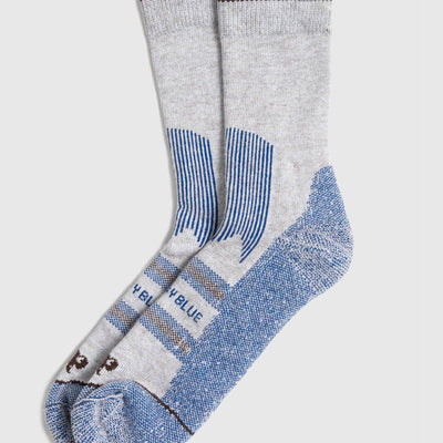 Blue Bison Wool Trail Sock (Flat-lay): Pair of grey crew socks with blue heel, toe, and stripe accents