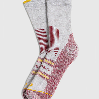 Red Bison Wool Trail Sock (Angle): Pair of grey crew socks with burgundy heel, toe, and stripe accents, yellow cuff trim
