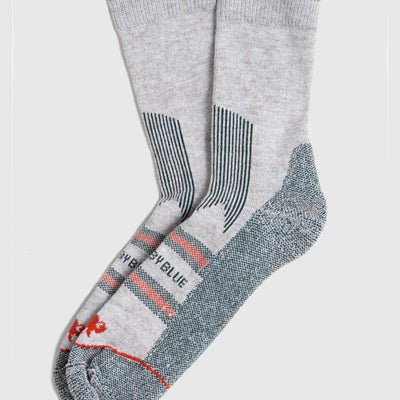 Green Bison Wool Trail Sock (Flat-lay): Pair of light grey crew socks with red cuff, teal heel and toe