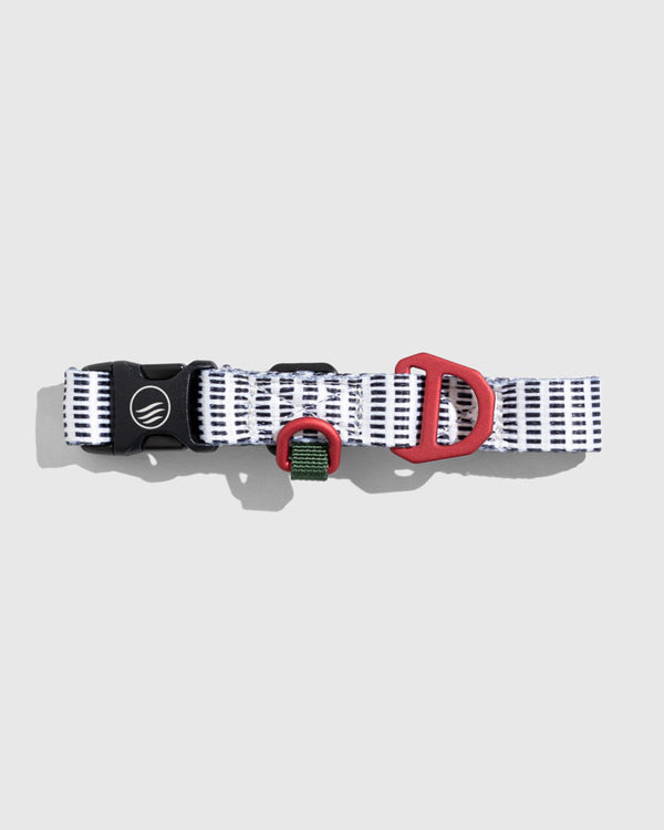 Shortbread (R)evolution™ Recycled Woven Dog Collar (Flat-lay): White and navy striped collar with black buckle and red D-ring hardware
