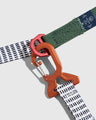 Shortbread (R)evolution™ Recycled Woven Dog Leash (Detail): Orange carabiner clip connects white grid-pattern strap to green webbing leash