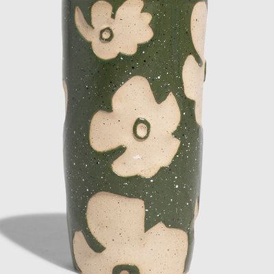 Forest Floor 10 oz. Insulated Stoneware Travel Mug (Angle): Cylindrical ceramic mug, olive green glaze with raised cream floral pattern, black lid