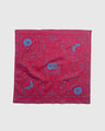 Beet Organic Bandana (Flat-lay): Red square bandana with blue celestial moon, sun, and tree prints