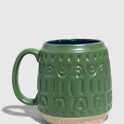 Pine 16 oz. Stoneware Mug (Angle): Green speckled stoneware mug with embossed arch pattern and navy interior