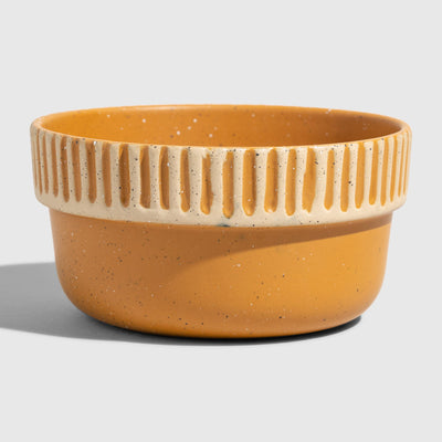 Caramel Stoneware Stackable Bowl (Angle): Round ceramic bowl, warm amber glaze, cream ribbed textured upper band