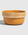 Caramel Stoneware Stackable Bowl (Angle): Round ceramic bowl, warm amber glaze, ribbed cream band near rim