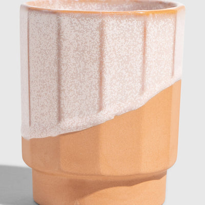 Foxglove 8 oz. Stackable Stoneware Tumbler (Angle): Ribbed stoneware cup with speckled blush glaze over terracotta base