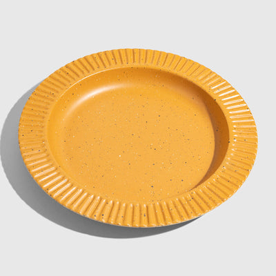 Caramel Stoneware Stackable Plate (Angle): Round golden-yellow speckled plate with ribbed scalloped rim, shallow well