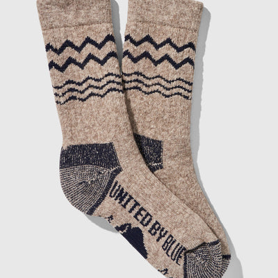 Navy The Ultimate Bison Wool Sock (Flat-lay): Tan crew socks with navy zigzag stripe, wave pattern, reinforced heel and toe