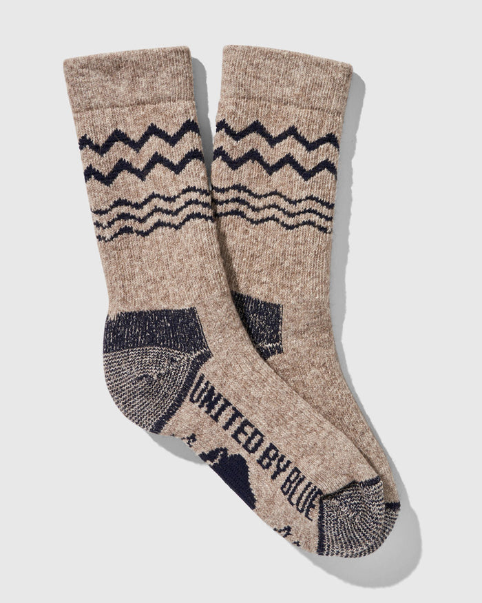 Navy The Ultimate Bison Wool Sock (Flat-lay): Tan crew socks with navy zigzag stripe, wave pattern, reinforced heel and toe