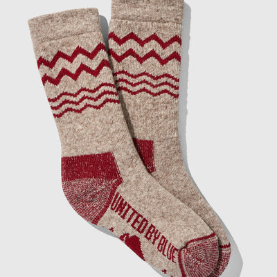 Red The Ultimate Bison Wool Sock (Flat-lay): Tan wool crew socks with red zigzag pattern and reinforced heel and toe