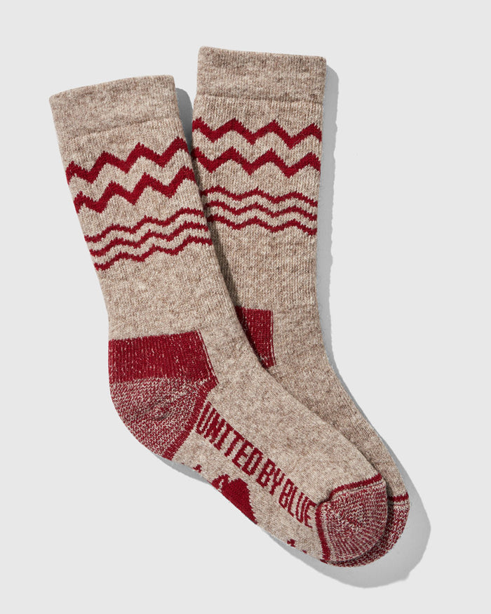 Red The Ultimate Bison Wool Sock (Flat-lay): Tan wool crew socks with red zigzag pattern and reinforced heel and toe
