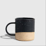 Black 8 oz. Stoneware Mug (Angle): Two-tone mug with matte black speckled glaze over natural unglazed base