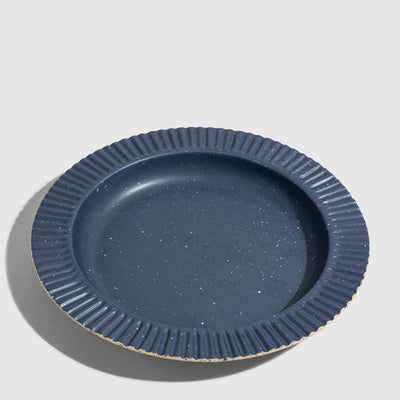 Slate Stoneware Stackable Plate (Angle): Round dark blue speckled plate with ribbed fluted rim and unglazed edge