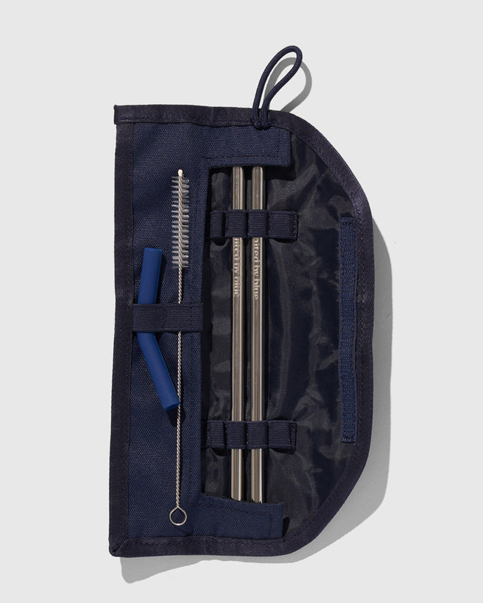 Navy The Straw Kit (Flat-lay): Open navy pouch with two metal straws, cleaning brush, and silicone tips