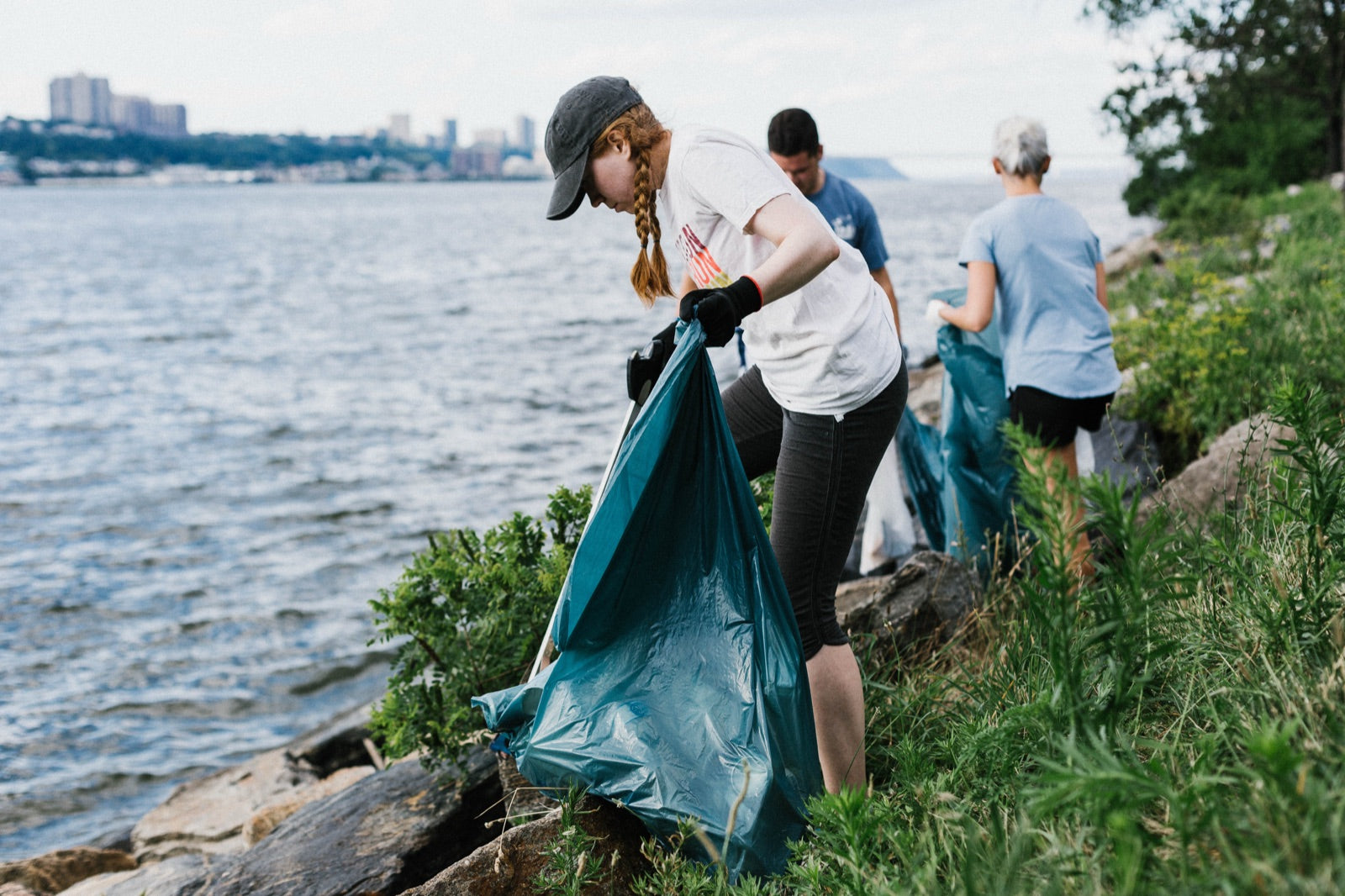 United By Blue waterway cleanup — volunteers removing trash from a shoreline.